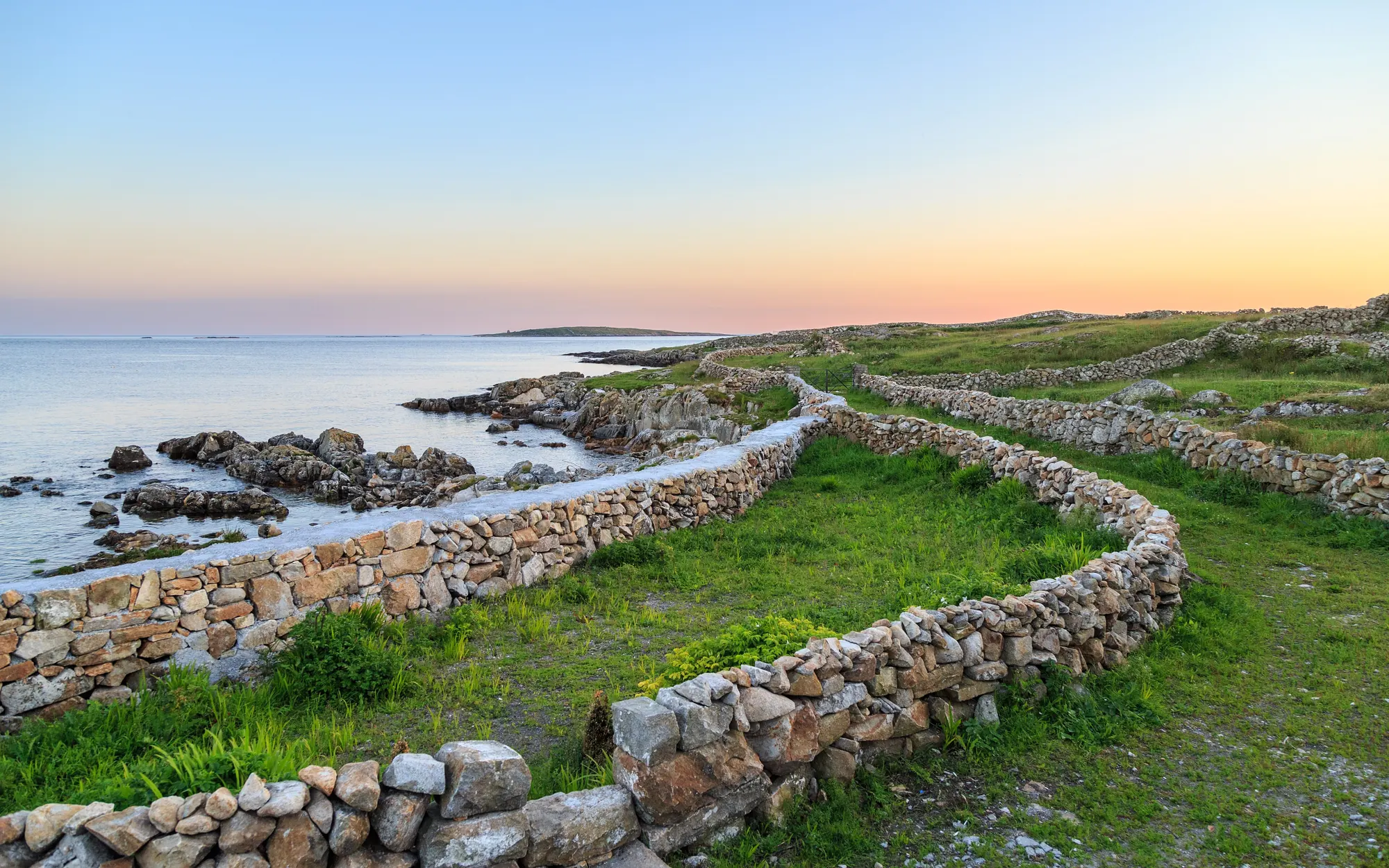 Dry stone walls along the Connemara coast near Carna at dusk